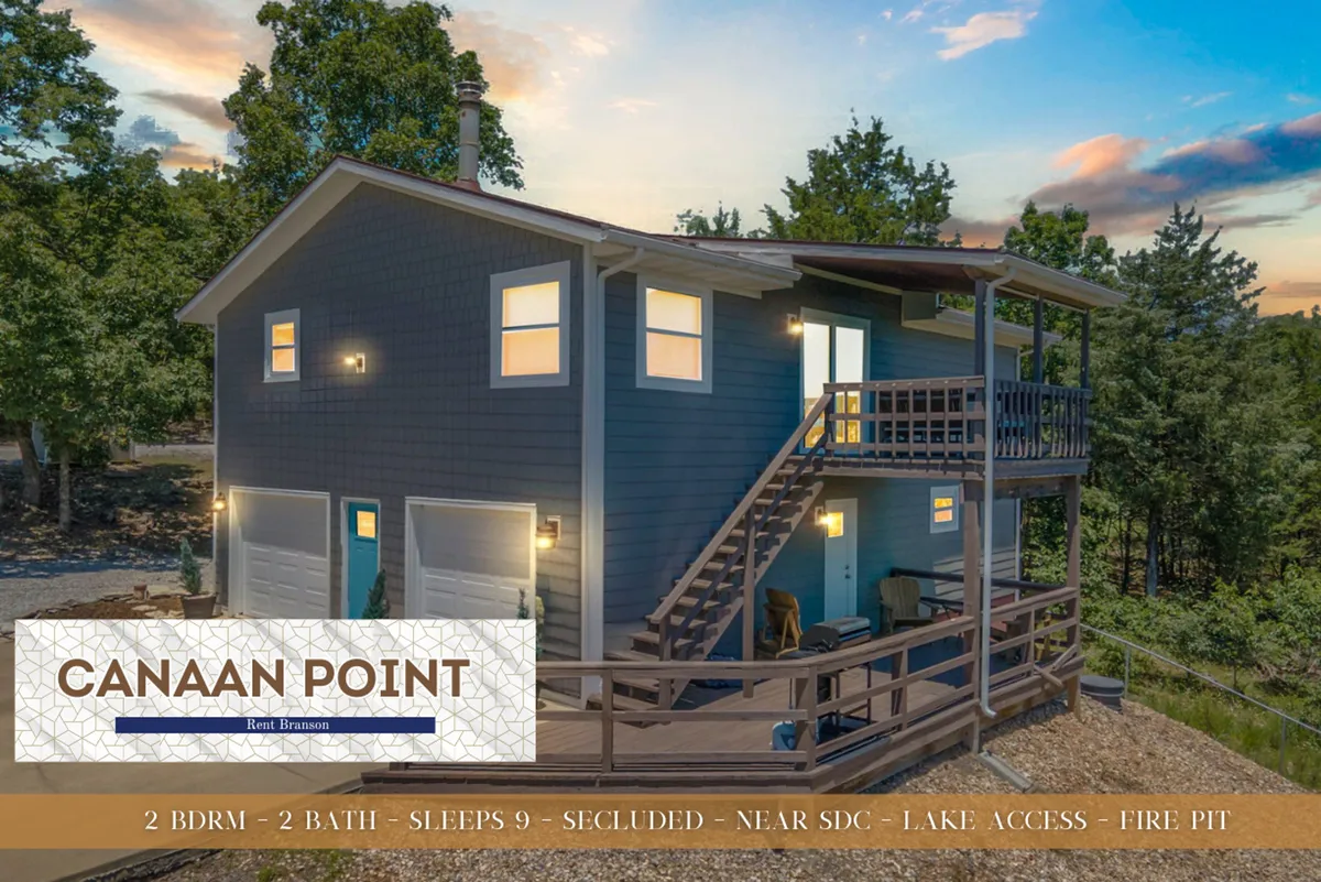The exterior of the house with a welcoming balcony and staircase surrounded by nature, suggesting seamless indoor-outdoor living. The setting hints at relaxing mornings or evenings spent outdoors, with the lake and recreational opportunities just beyond the trees.